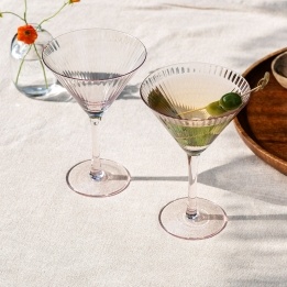 Two pink ridged martini glasses with elegant stemmed design.