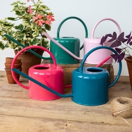 metal watering cans in different colour.