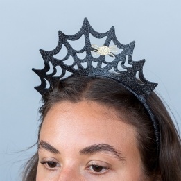 Black glitter spiderweb headband with a gold spider decoration.