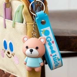 Bear bag charm with blue outfit, silicone wrist strap and silver keyring