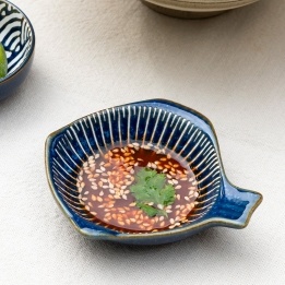Fish-shaped blue ceramic dipping bowl shown with dipping sauce.