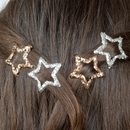 Silver and gold glitter star hair clips in a set of four.