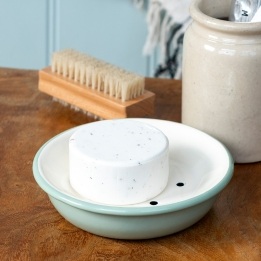 Round two-part soap dish with drainage holes in sage green.