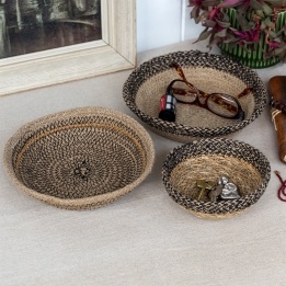 Round decorative bowl with natural and black woven detail.