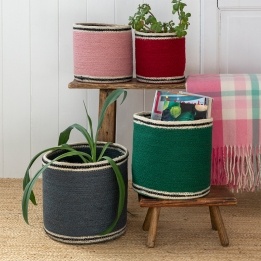 Set of four nested woven jute baskets in grey, green, pink and red
