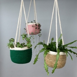 Alt text: Seagrass hanging basket with loop, shown with plants and different coloured.