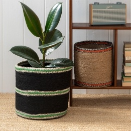 Set of two round jute storage baskets in natural and black.