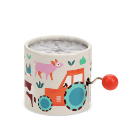 Farmyard‑themed winding music box with illustrated tractor and animals, featuring a red turning handle.
