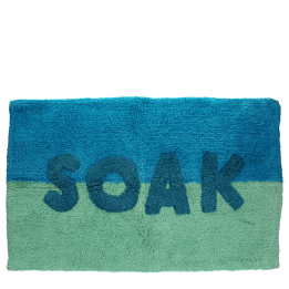 Blue and green bath mat with the word ‘SOAK’ in the center.
