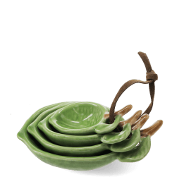 stackable ceramic measuring spoons shaped like green leaves with brown stem handles