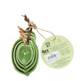 Stackable ceramic measuring spoons shaped like green leaves with brown stem handles with tag