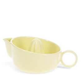Yellow stoneware lemon squeezer with handle and pouring spout.