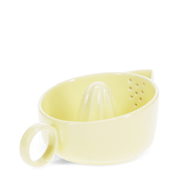 Yellow stoneware lemon squeezer with handle and pouring spout.