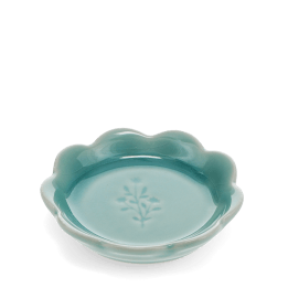 Ceramic trinket dish with a scalloped edge and a floral design in the centre.