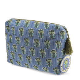 Blue quilted wash bag in blue with a green and blue floral print and a tag.