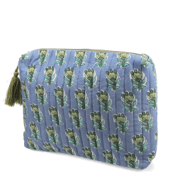 Blue quilted wash bag in blue with a green and blue floral print.