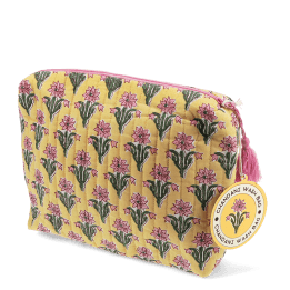 Yellow quilted wash bag with a pink and green flowers design and a tag.