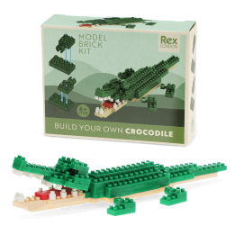 Completed crocodile brick model displayed beside its packaging box.