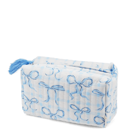Light blue quilted makeup bag with a bow pattern and tassel.