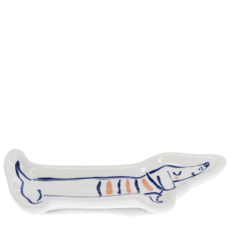 White ceramic trinket dish shaped like a long sausage dog with blue and orange details.