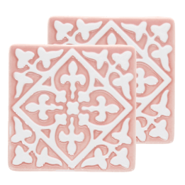 Set of two pink ceramic coaster with embossed pattern.