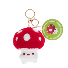 Plush mushroom bag charm with red spotted cap, gold keyring and soft white base with tag.