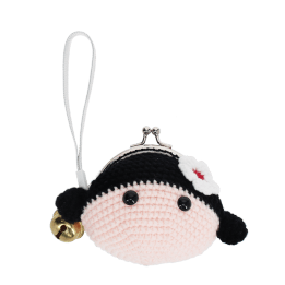 Crochet girl-shaped coin purse with a metal clasp and hanging bell charm.