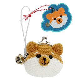 Crochet fox-shaped coin purse with a metal clasp and hanging bell charm with tag.
