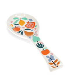 White ceramic spoon rest with a colourful fruit and leaf design.