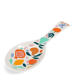 White ceramic spoon rest with a colourful fruit and leaf design.