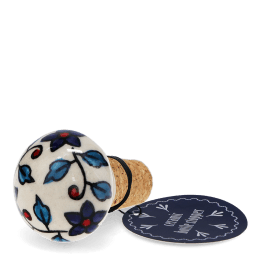 Ceramic and cork bottle stopper with floral and leaf pattern with tag.