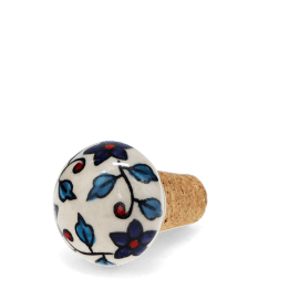 Ceramic and cork bottle stopper with floral and leaf pattern.