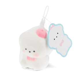 White bear squishy toy with pink bow, packaged in mesh netting with hanging tag.