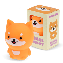 Orange dog-shaped squishy toy with smiling face, shown beside matching display box.