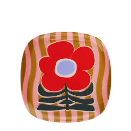 Square metal trinket tray with bold red flower design on a pink striped background.