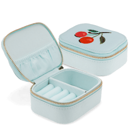 Open light blue jewellery box with embroidered cherry design, ring rolls and storage compartments.