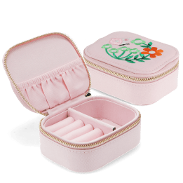 Open pink jewellery box with embroidered floral design, ring rolls and storage compartments.