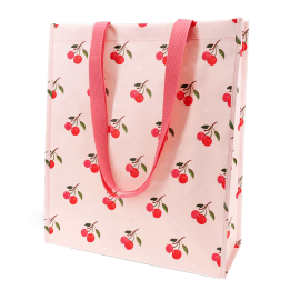 Light pink shopping bag with cherry print design and matching pink carry handles.