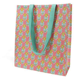 Pink shopping bag with floral block-print pattern and carry handles.