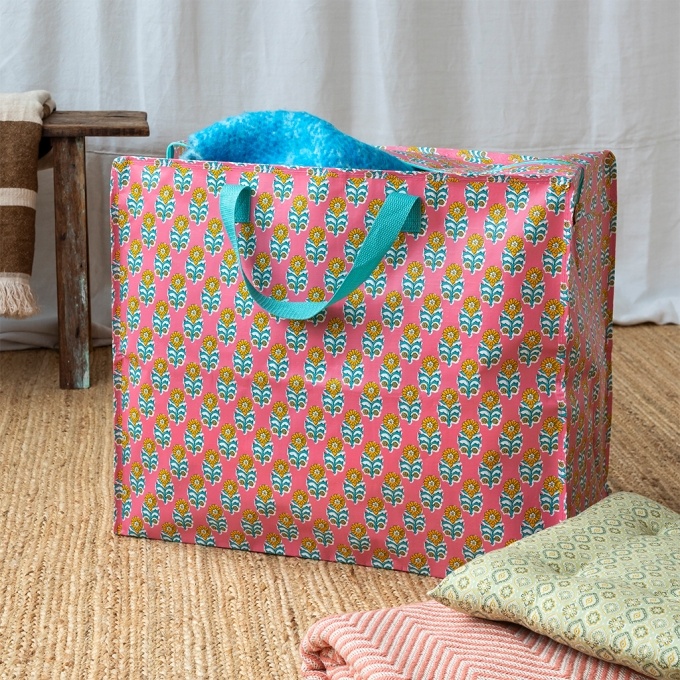 Pink jumbo storage bag with colourful floral designs.