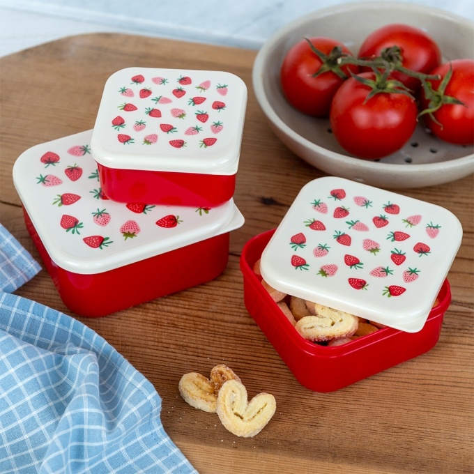 A set of three stackable snack boxes decorated with cookies.