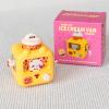 yellow wind up ice cream van with pink packaging box in background