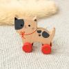 wooden push-along cat toy with red wheels