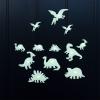 Various glowing dinosaur species on a black background