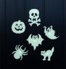Six assorted Halloween-themed glow-in-the-dark shapes on a black background.