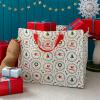 Christmas storage bag with festive designs, filled with presents