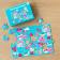Small jigsaw puzzle with retro style Top Banana print being put together on table
