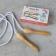 Traditional nylon skipping rope with wooden handles on ground with box
