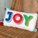 Embroidered cushion with pom poms - Joy