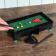 Table top snooker game set up with balls, cues, and rack 